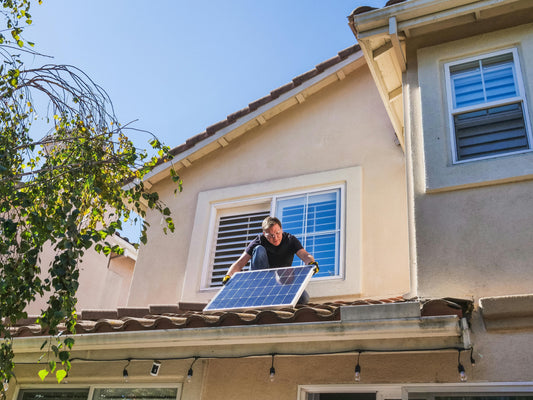 a man fixing on roof 100w portale solar panel kit Australia 