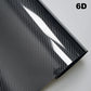 Carbon fiber vinyl wrap sheet with a textured pattern on a gray background