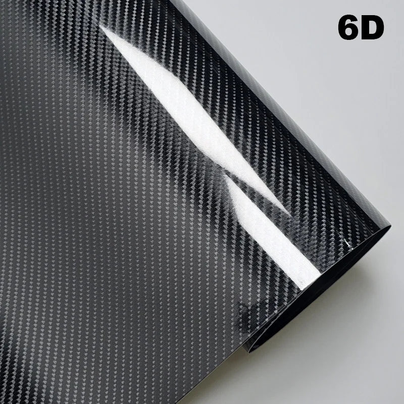 Carbon fiber vinyl wrap sheet with a textured pattern on a gray background