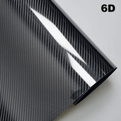 Carbon fiber vinyl wrap sheet with a textured pattern on a gray background